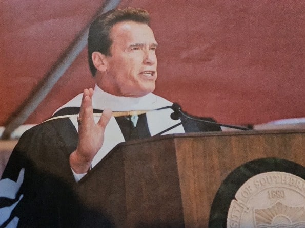 Arnold Schwarzenegger talking at a commencement speech