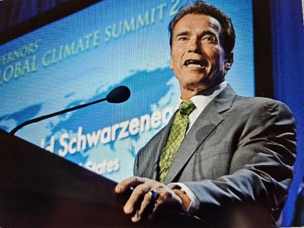 Arnold Schwarzenegger standing at climate change summit
